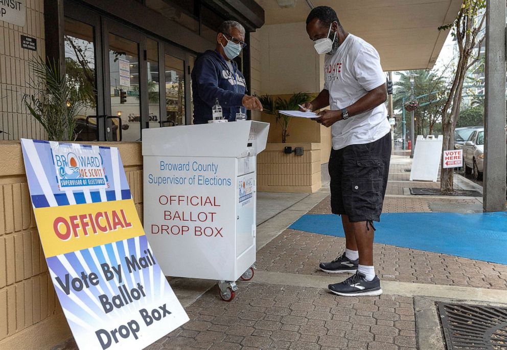 PHOTO: Wilbur Harbin prepares to place his ballot in a vote by mail ballot drop box during the Congressional district 20 elections, Jan. 11, 2022, in Ft. Lauderdale, Fla.