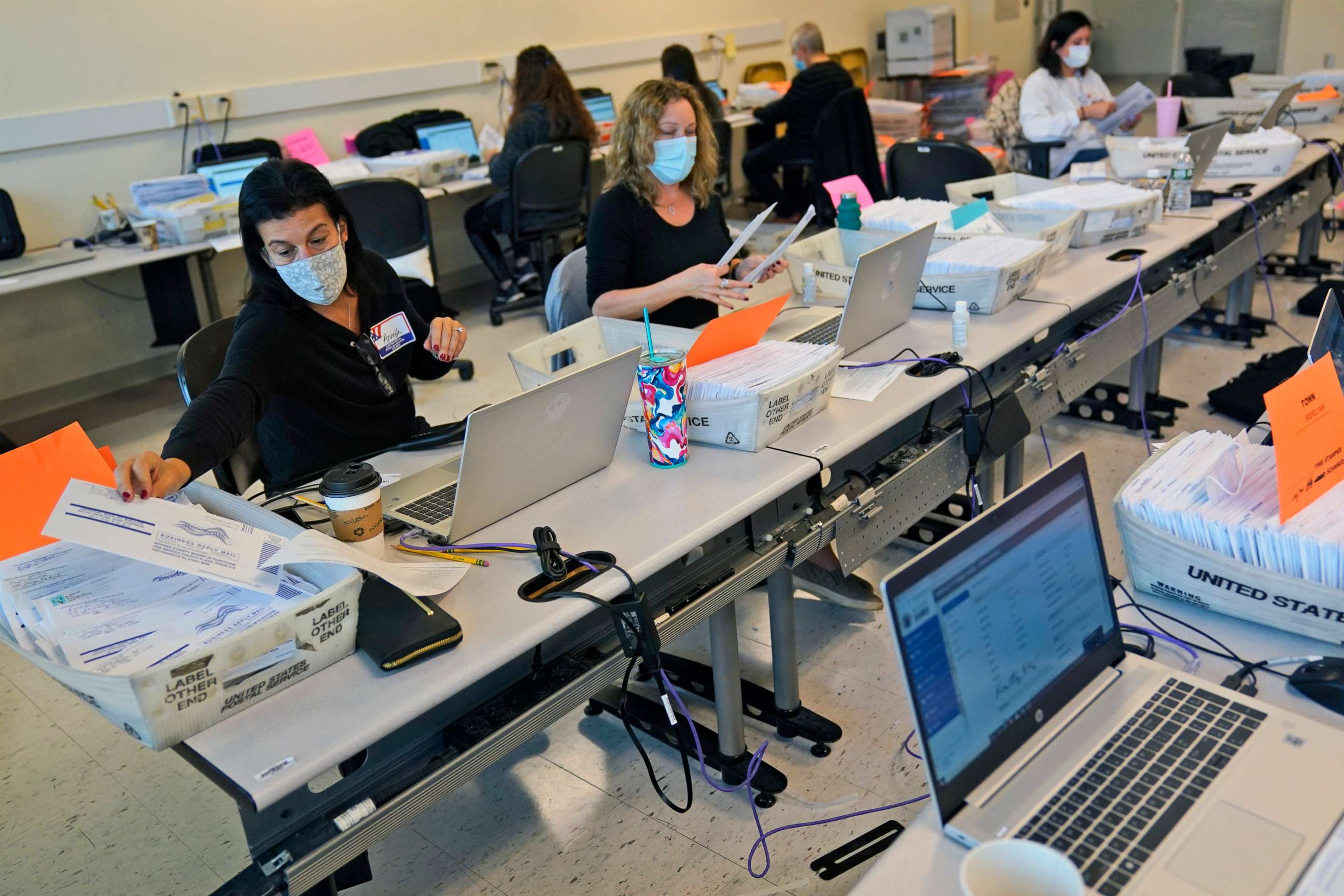 PHOTO: Ballot board workers verify the signatures on mail-in ballots at Bergen Community College in Paramus, N.J., Oct. 24, 2020.