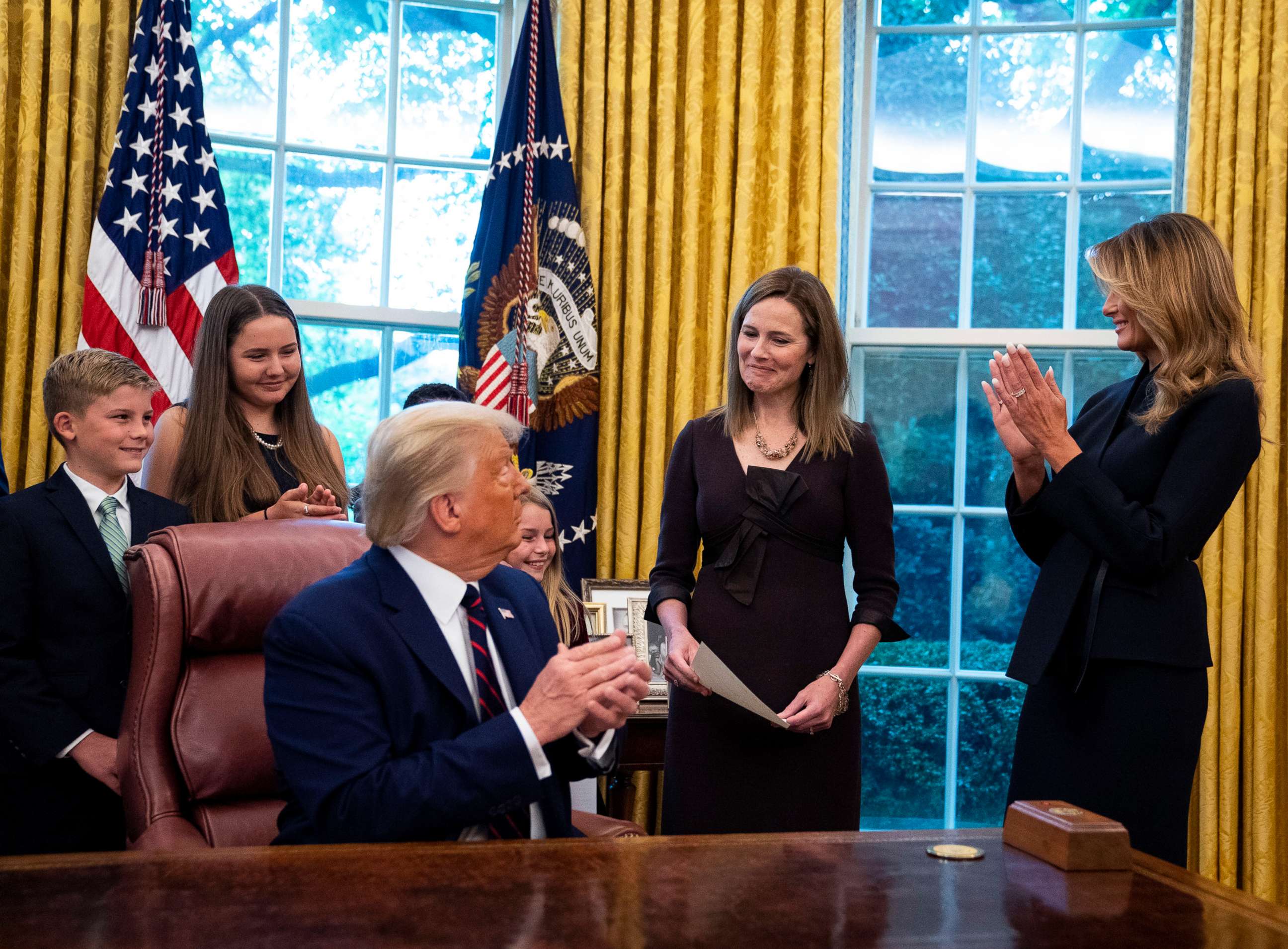 PHOTO: President Donald Trump and first lady Melania Trump with Judge Amy Coney Barrett and her family in the Oval Office of the White House, Sept. 26, 2020, prior to his public announcement in the Rose Garden.