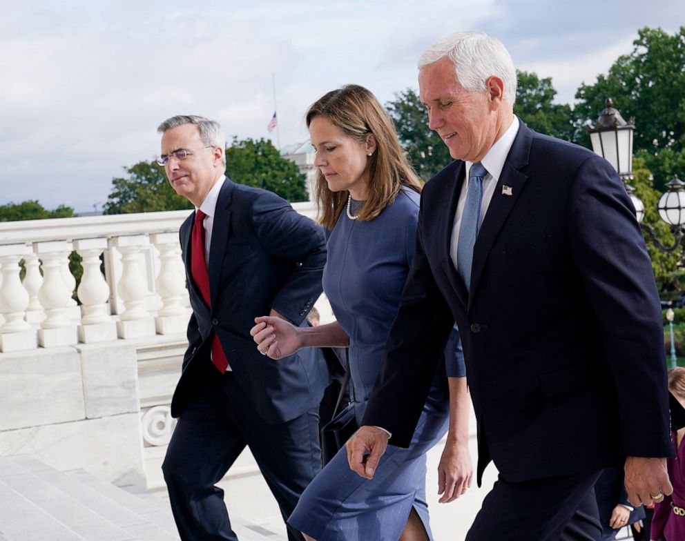 PHOTO: Judge Amy Coney Barrett is escorted to the Senate by Vice President Mike Pence, right, where she will begin a series of meetings to prepare for her confirmation hearing, at the Capitol in Washington, Sept. 29, 2020.