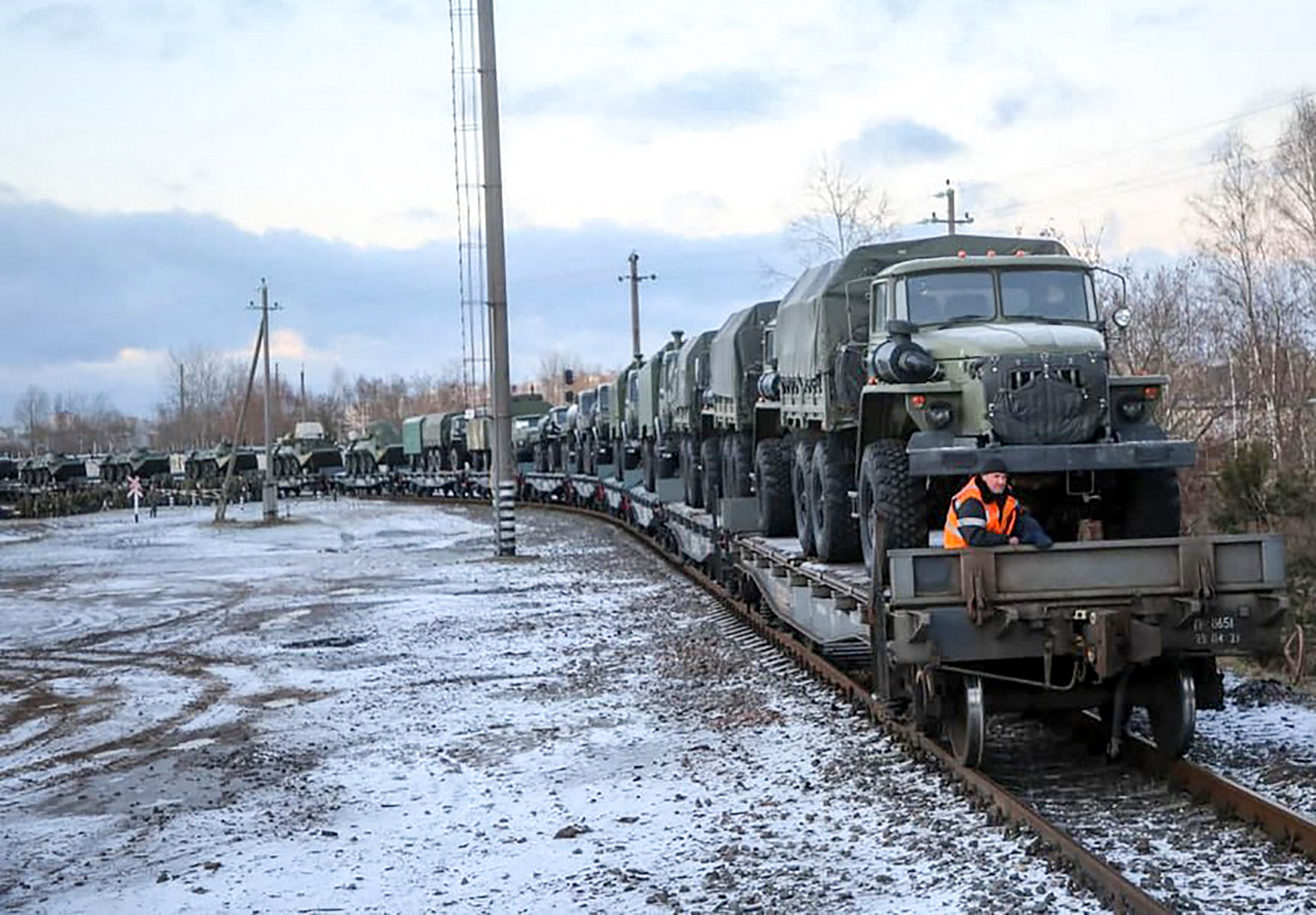 PHOTO: This handout photograph released on Jan. 18, 2022 by Belarus' Defense Ministry, shows a Russian troop train transporting military vehicles arriving for drills in Belarus. 