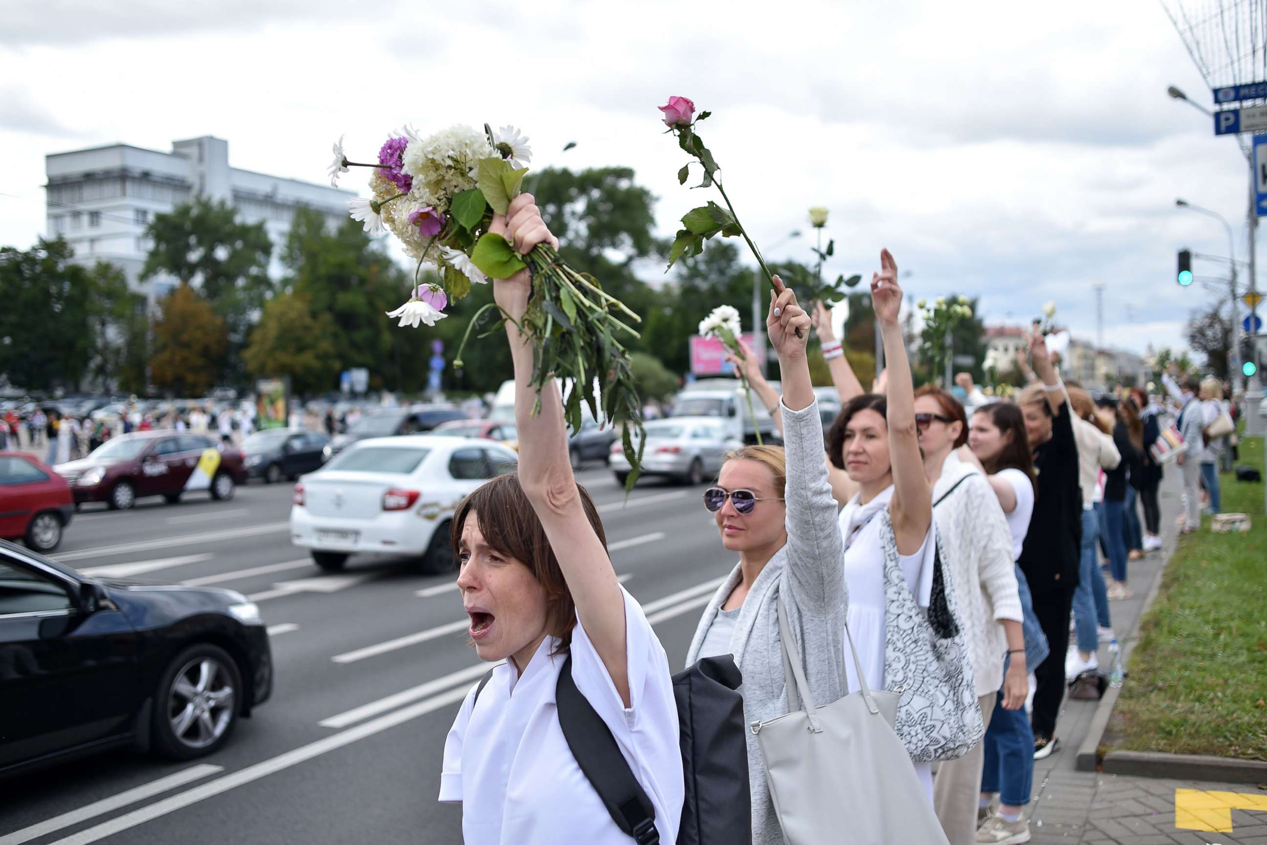 PHOTO: Women with flowers protest against police violence during recent rallies by opposition supporters, who accuse strongman Alexander Lukashenko of falsifying the polls in the presidential election, in Minsk, Belarus, on Aug. 13, 2020.