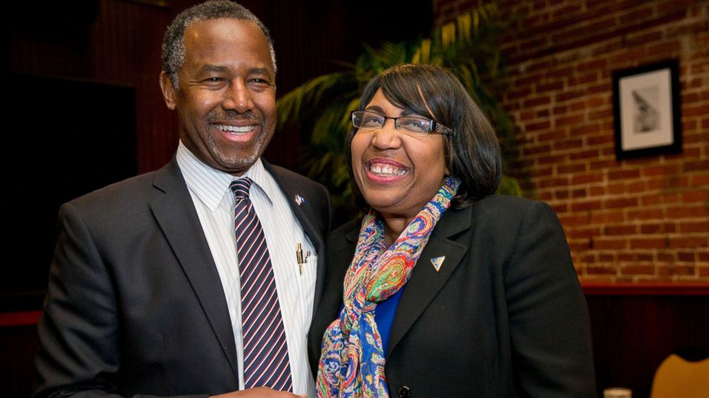 Ben Carson spends a moment with his wife Candy Carson as she arrives for a Valentine's Day dinner at the Blue Marlin restaurant in Columbia, S.C., Feb. 14, 2016.