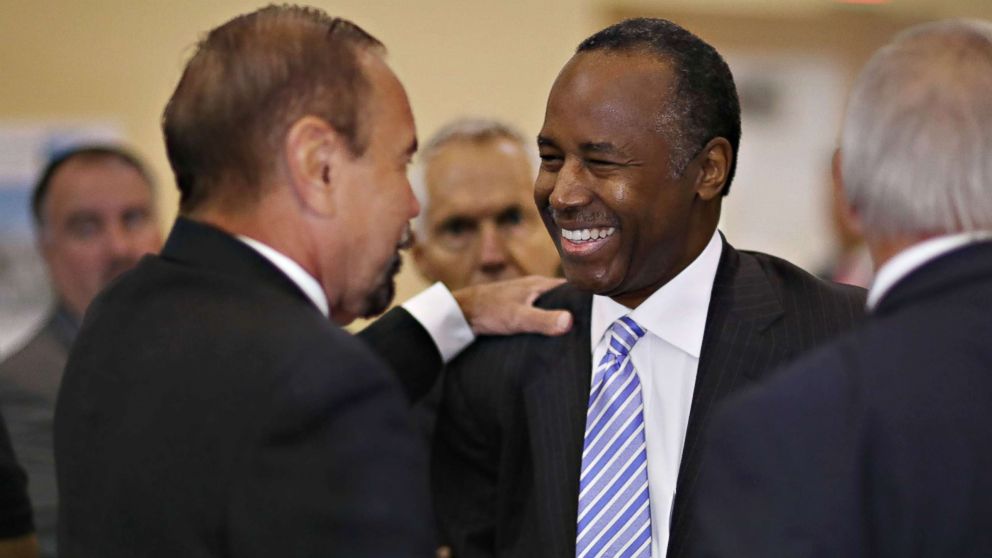 Housing and Urban Development Secretary Ben Carson speaks with Jorge Perez, CEO of Related Urban Group, left, during a visit to the Liberty Square apartment complex on April 12, 2017 in Miami. Secretary Carson is on a national listening tour to hear from the people and organizations who rely on and support public housing. 