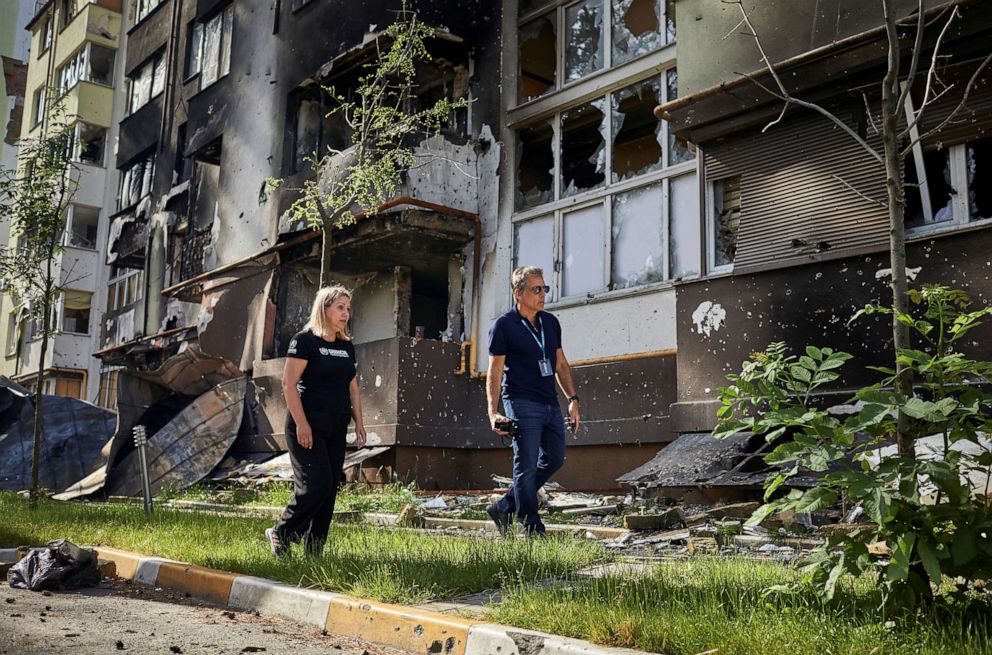 PHOTO: Hollywood Actor and Goodwill Ambassador Ben Stiller walks with UNHCR Regional Public Information Officer Natalia Prokopchuk past a damaged building as he visits the Lypki neighbourhood in Irpin, Ukraine, in this photo released June 20, 2022.