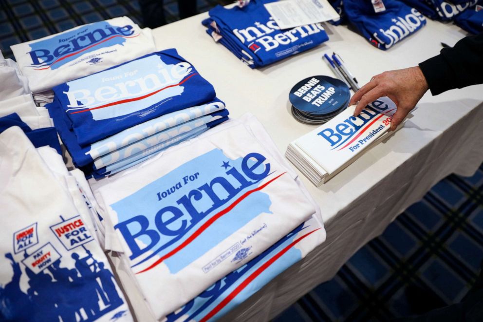 PHOTO: Supporters pick up bumper stickers of Democratic presidential candidate Sen. Bernie Sanders at a climate rally with Rep. Rashida Tlaib and Rep. Ro Khanna in Iowa City, Iowa, on Jan. 12, 2020.