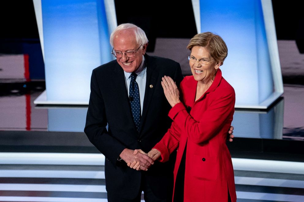 PHOTO: Sens. Bernie Sanders and Elizabeth Warren greet each other at the start of the first night of Democratic presidential debates at the Fox Theater in Detroit, July 30, 2019.