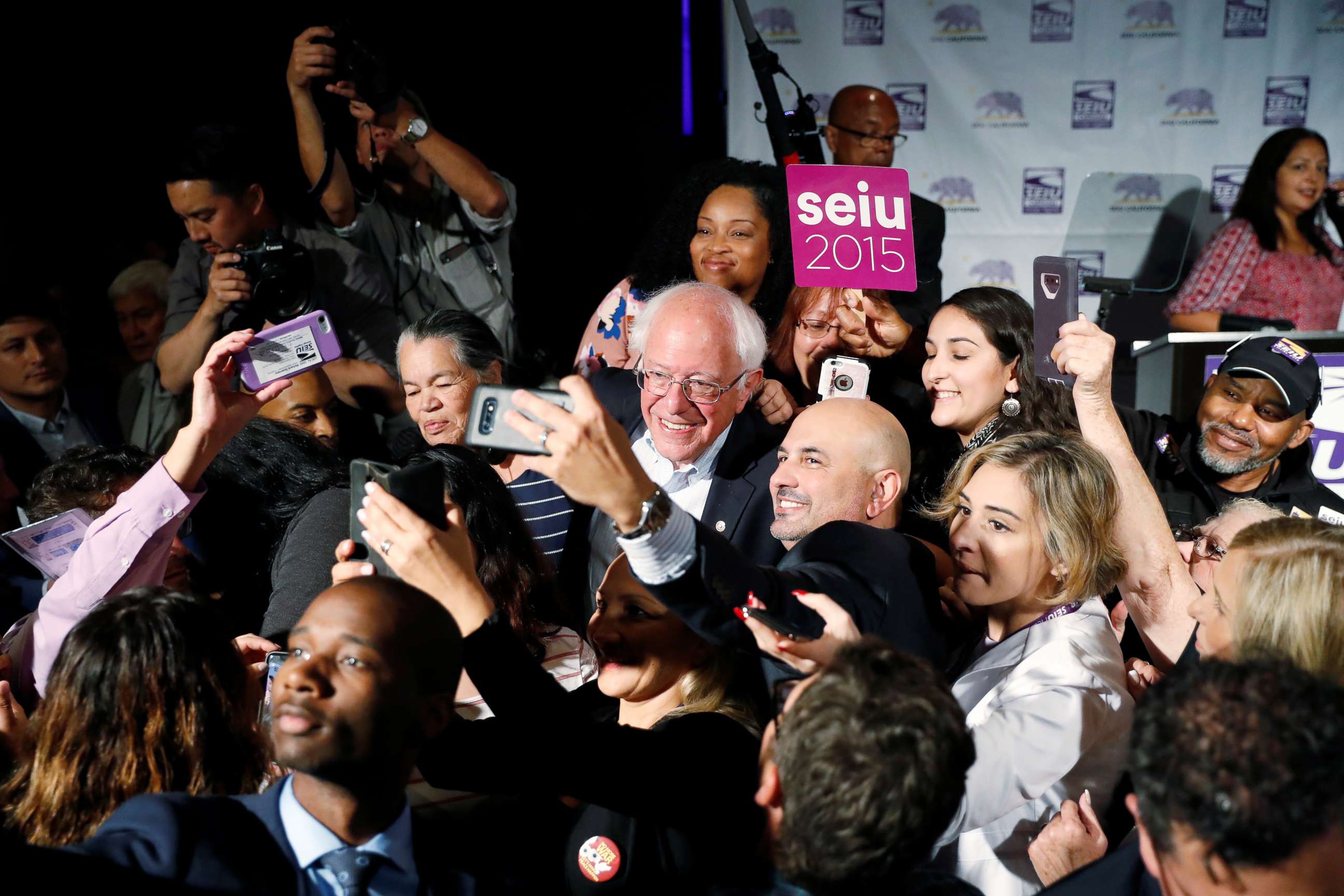 PHOTO: Democratic presidential candidate and U.S. Senator Bernie Sanders takes a selfie with supporters during a SEIU California Democratic Delegate Breakfast in San Francisco, June 1, 2019.