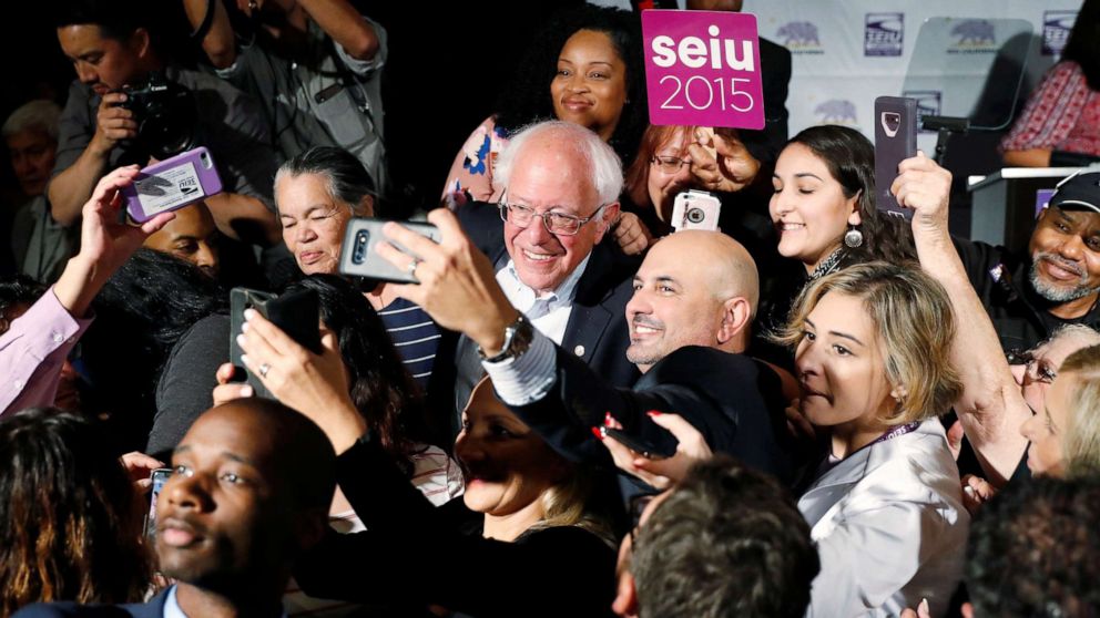PHOTO: Democratic presidential candidate and U.S. Senator Bernie Sanders takes a selfie with supporters during a SEIU California Democratic Delegate Breakfast in San Francisco, June 1, 2019.