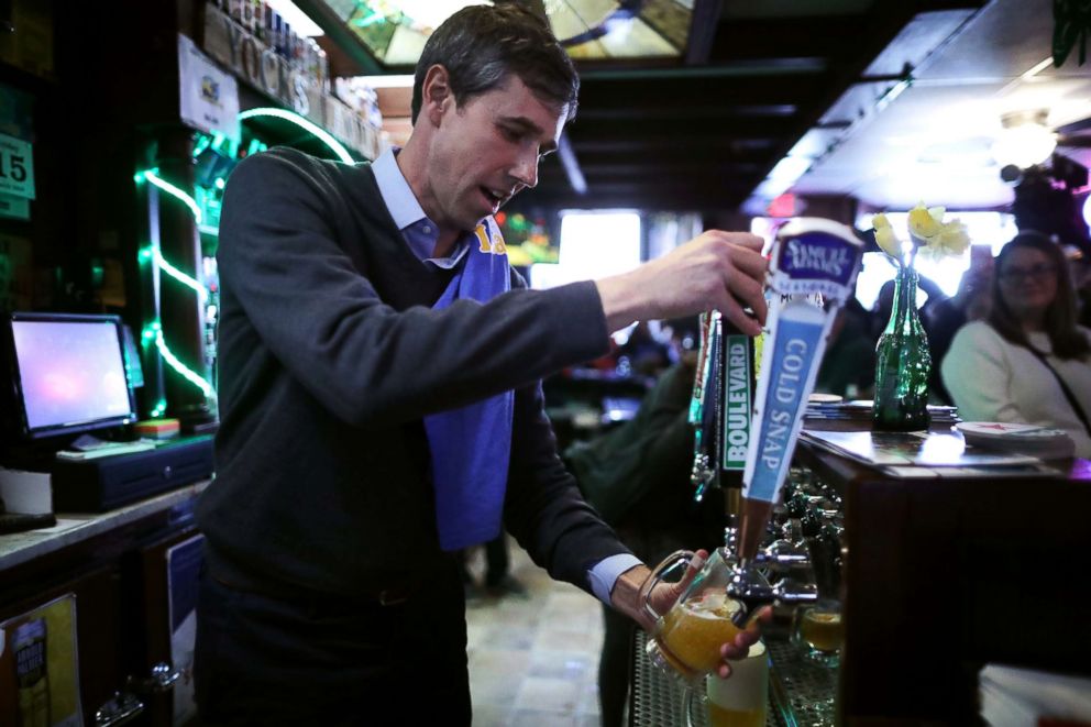 PHOTO: Democratic presidential candidate Beto O'Rourke pours a beer for a customer at Yock's Landing during his second day of campaigning for the 2020 nomination, March 15, 2019, in Mount Vernon, Iowa.