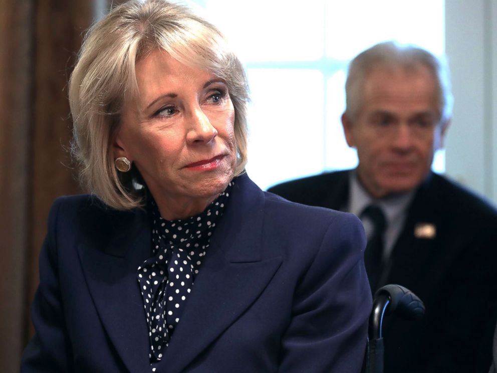 PHOTO: State Secretary for Education, Betsy DeVos, listens to US President Donald Trump speaking to reporters at a cabinet meeting at the White House in Washington, DC on February 12, 2019 .