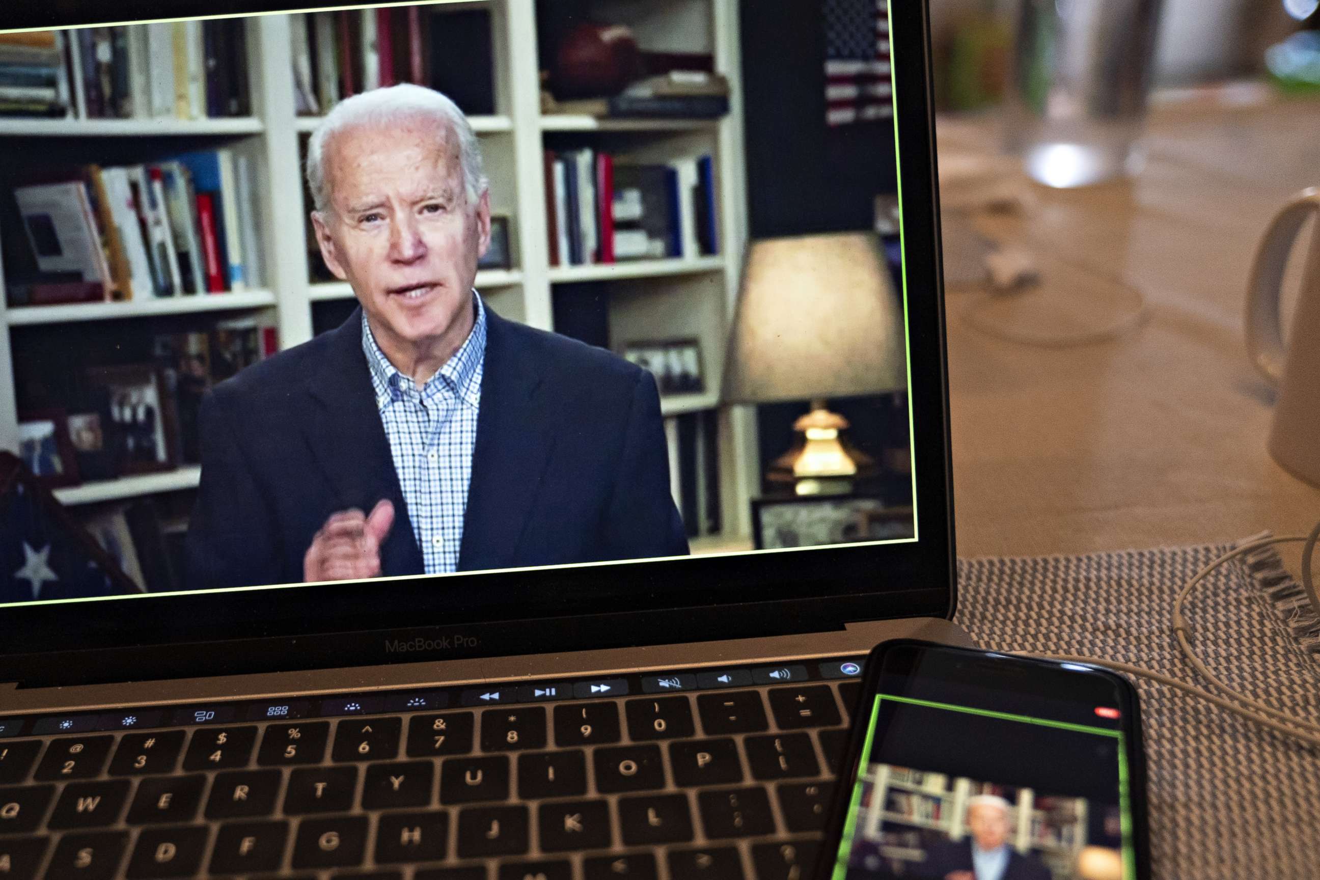 PHOTO: Former Vice President Joe Biden, 2020 Democratic presidential candidate, speaks during a virtual press briefing on a laptop computer in this arranged photograph in Arlington, Virginia, U.S., on Wednesday, March 25, 2020.