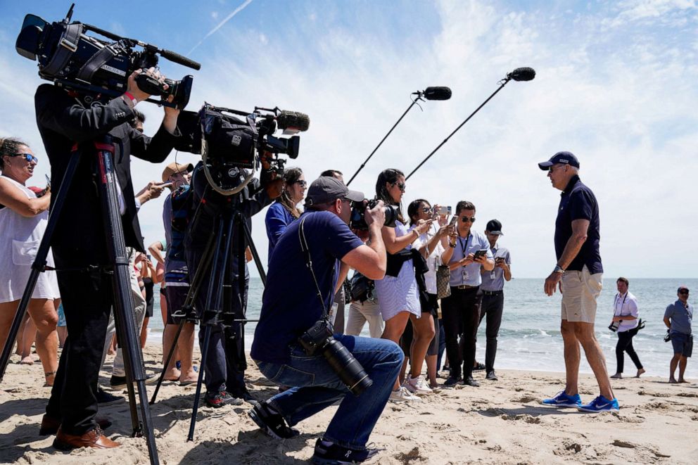 PHOTO: President Joe Biden speaks with reporters during a walk on the beach with family members near Gordons Pond in Cape Henlopen State Park, Rehoboth Beach, Delaware, on June 20, 2022.