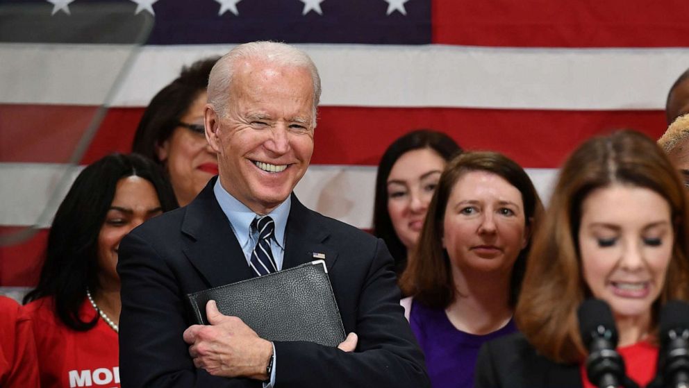 PHOTO: Democratic presidential candidate Joe Biden looks on as Shannon Watts, Founder of Moms Demand Action speaks during a campaign stop at Driving Park Community Center in Columbus, Ohio, March 10, 2020. 