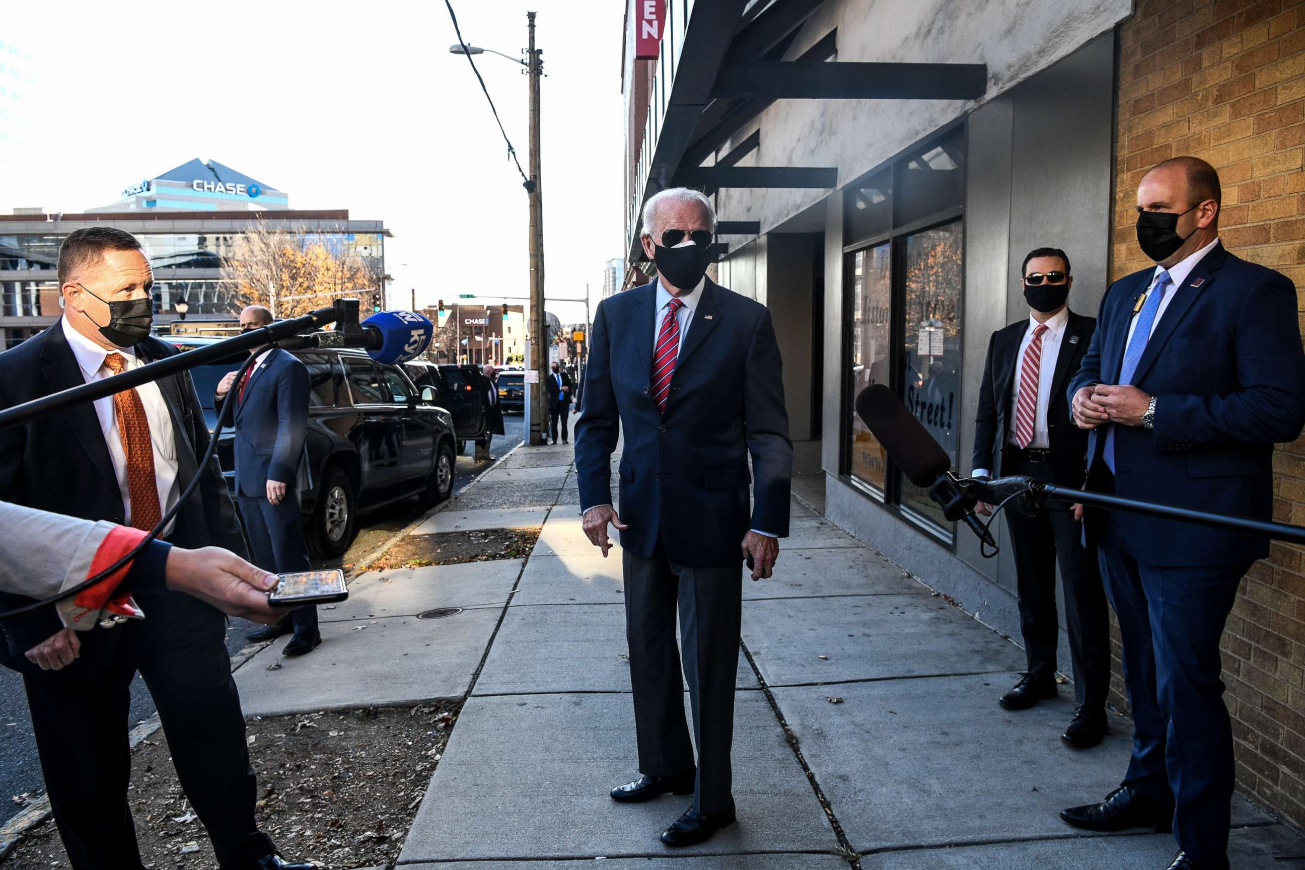 PHOTO: President-elect Joe Biden talks to the media as he arrives at the Queen to meet virtually with the United States Conference of Mayors in Wilmington, Del., Nov. 23, 2020.