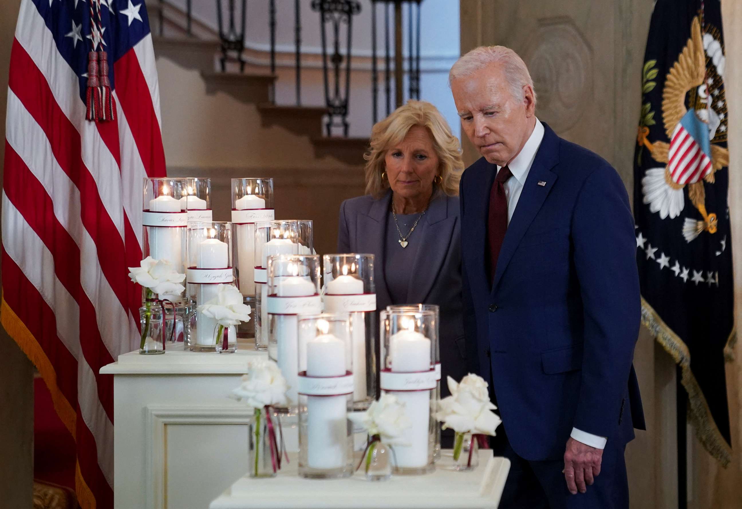 PHOTO: President Joe Biden and first lady Jill Biden pause to look at a display of candles a year after the school shooting at Robb Elementary School in Uvalde, Texas, during an event at the White House, May 24, 2023.