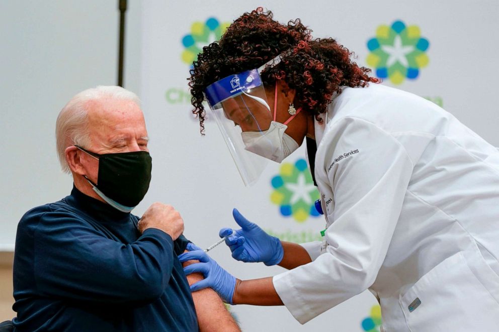 PHOTO: President Joe Biden receives a Covid-19 vaccination from Tabe Masa, Nurse Practitioner and Head of Employee Health Services, at the Christiana Care campus in Newark, Delaware, Dec. 21, 2020.