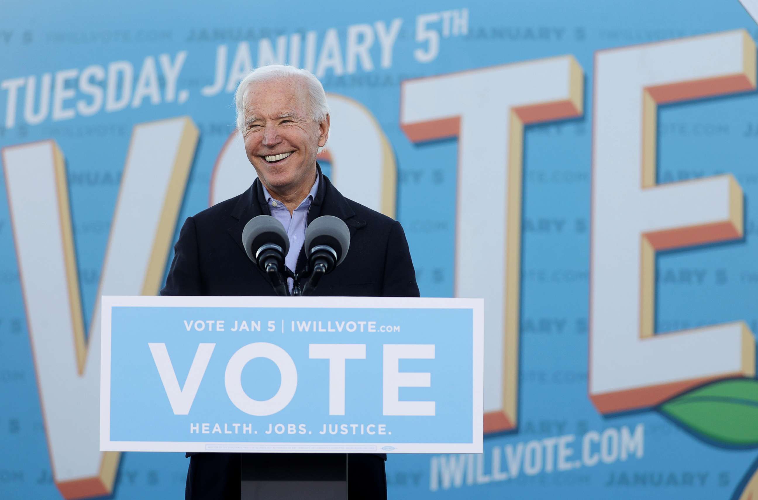 PHOTO: President-elect Joe Biden speaks as he campaigns on behalf of Democratic U.S. Senate candidates from Georgia Jon Ossoff and Raphael Warnock, ahead of their January 5 run-off elections, during a drive-in campaign rally in Atlanta, Jan. 4, 2021.