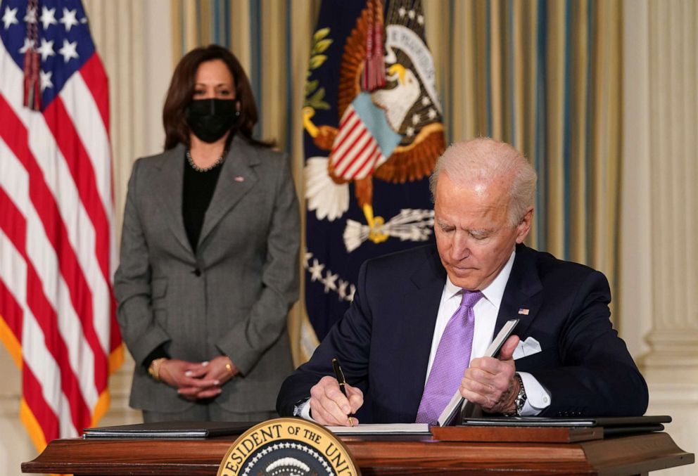 PHOTO: Vice President Kamala Harris watches as President Joe Biden signs executive orders on his racial equity agenda at the White House, Jan. 26, 2021. 