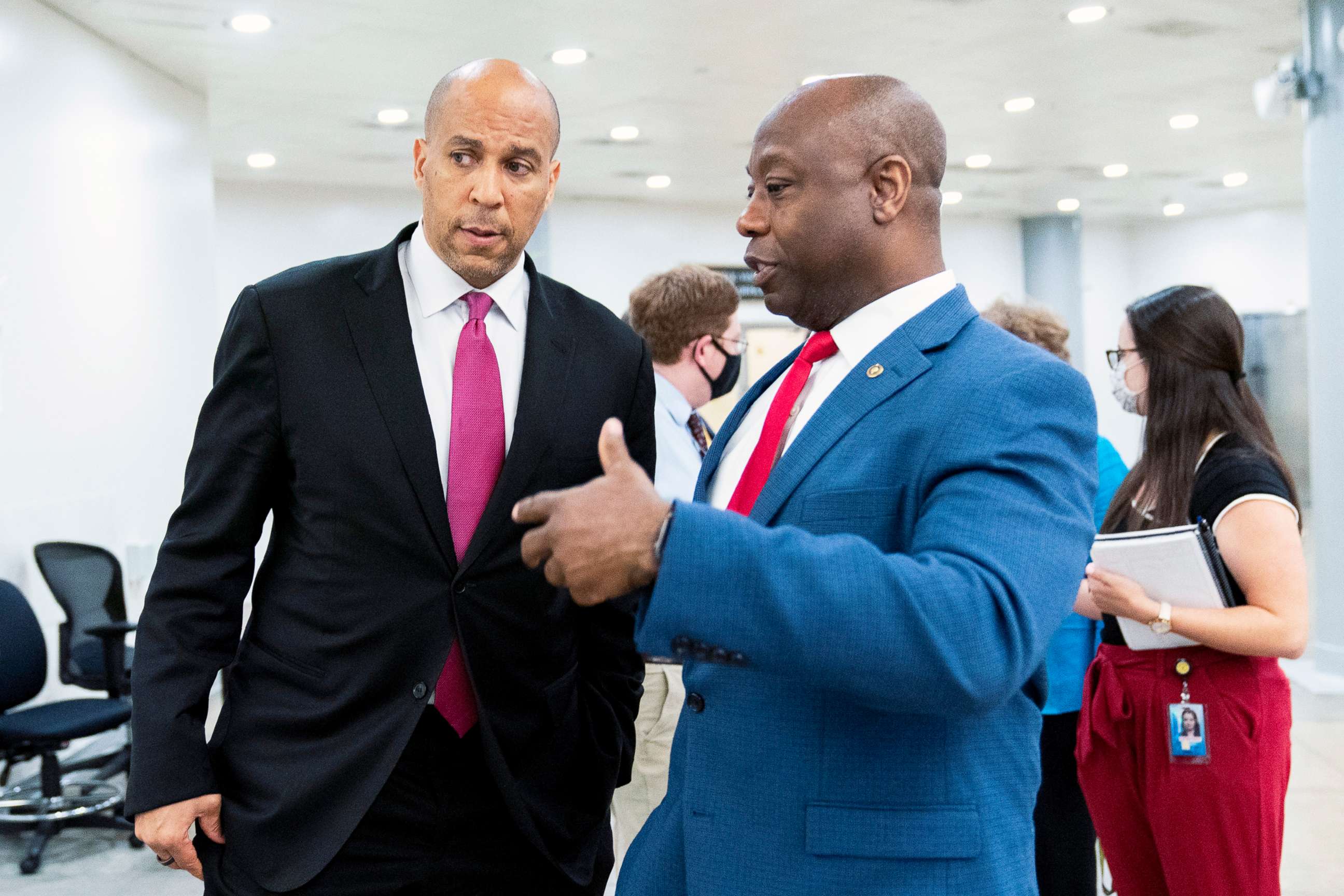 PHOTO: Sen. Cory Booker and Sen. Tim Scott talk as they wait for a Senate subway train on Capitol Hill in Washington, July 30, 2021.