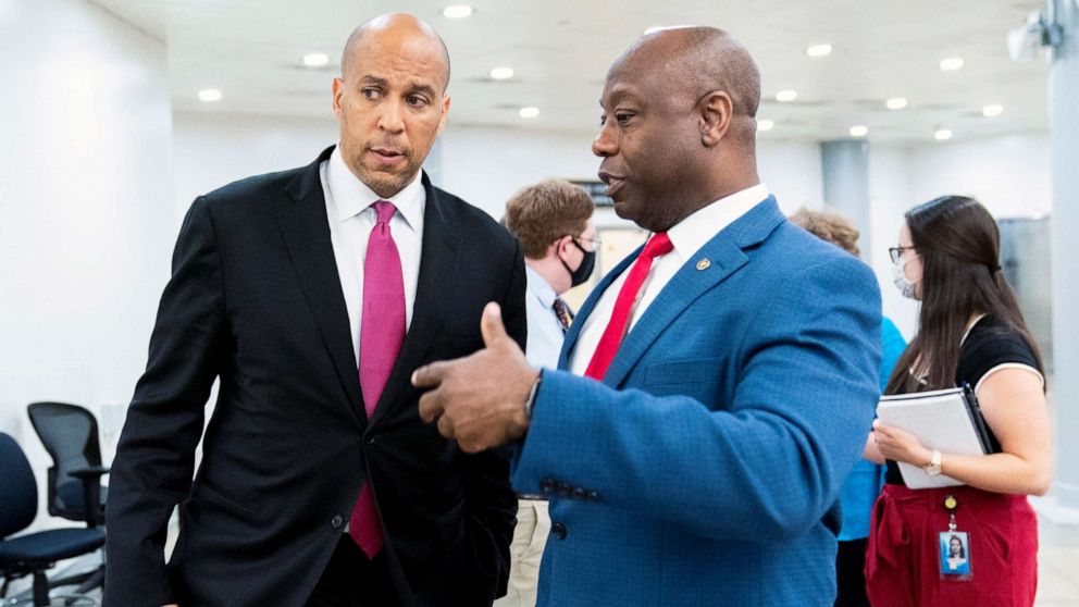 PHOTO: Sen. Cory Booker and Sen. Tim Scott talk as they wait for a Senate subway train on Capitol Hill in Washington, July 30, 2021.