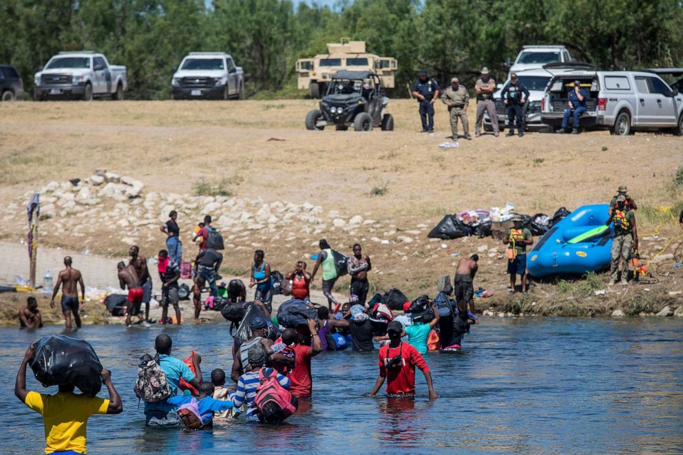 PHOTO: Migrants cross the Rio Grande towards Del Rio, Texas, from Mexico, Sept. 23, 2021. 