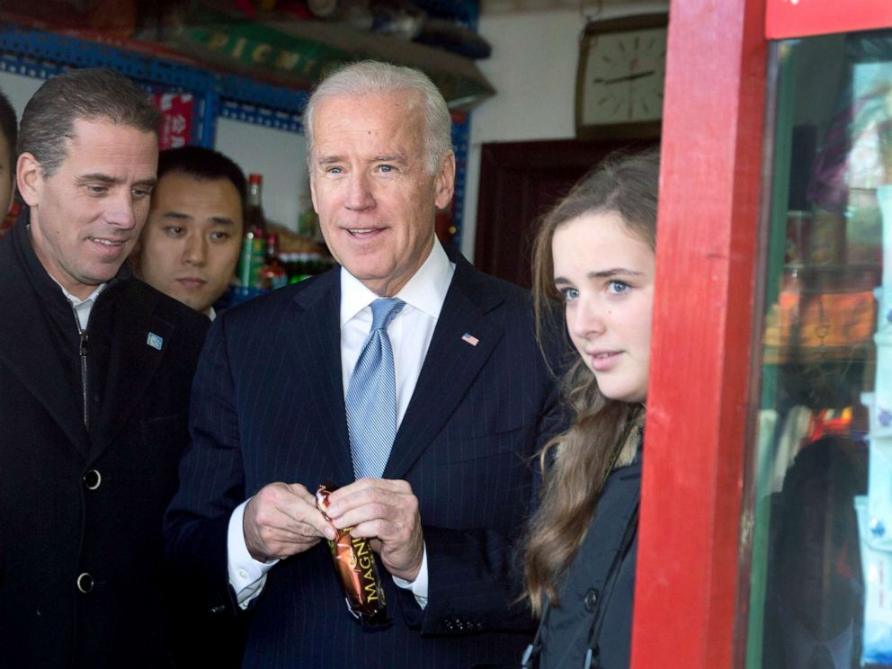 PHOTO: Vice President Joe Biden, center, buys an ice-cream at a shop as he tours a Hutong alley with his granddaughter Finnegan Biden, right, and son Hunter Biden, left, in Beijing, China, Dec. 5, 2013.