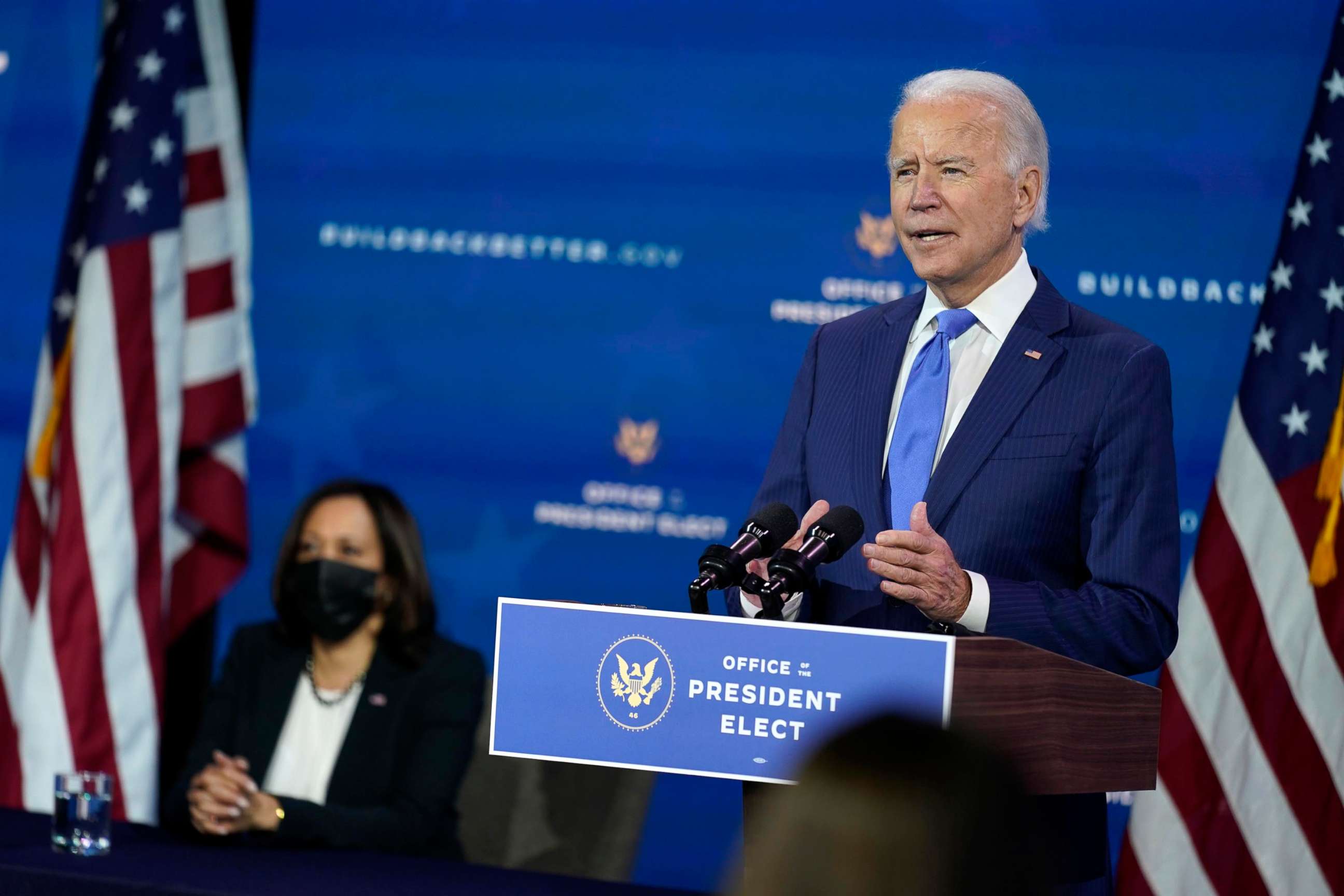 PHOTO: President-elect Joe Biden speaks as Vice President-elect Kamala Harris listens during an event to introduce their nominees and appointees to economic policy posts at The Queen theater, Dec. 1, 2020, in Wilmington, Del.