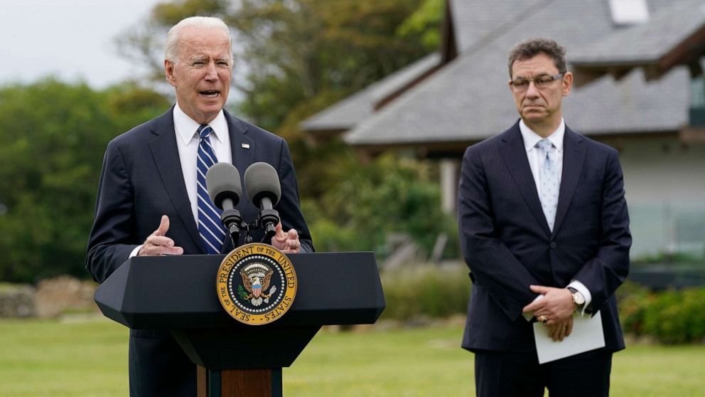 PHOTO: President Joe Biden speaks about his administration's global COVID-19 vaccination efforts ahead of the G-7 summit, June 10, 2021, in St. Ives, England. Pfizer CEO Albert Bourla listen at right.