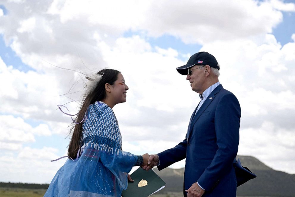 PHOTO: Maya Telosi, a member of the Hopi tribe, the Grand Canyon Havasupai tribe, and the Chiene and Arapaho tribes, shake hands with President Joe Biden at Red Boat Airport, August 8, 2023.