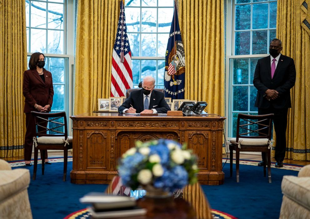 PHOTO: Flanked by Vice President Kamala Harris and Secretary of Defense Lloyd Austin, President Joe Biden signs an executive order repealing the ban on transgender people serving openly in the military, at the White House, Jan. 25, 2021, in Washington.