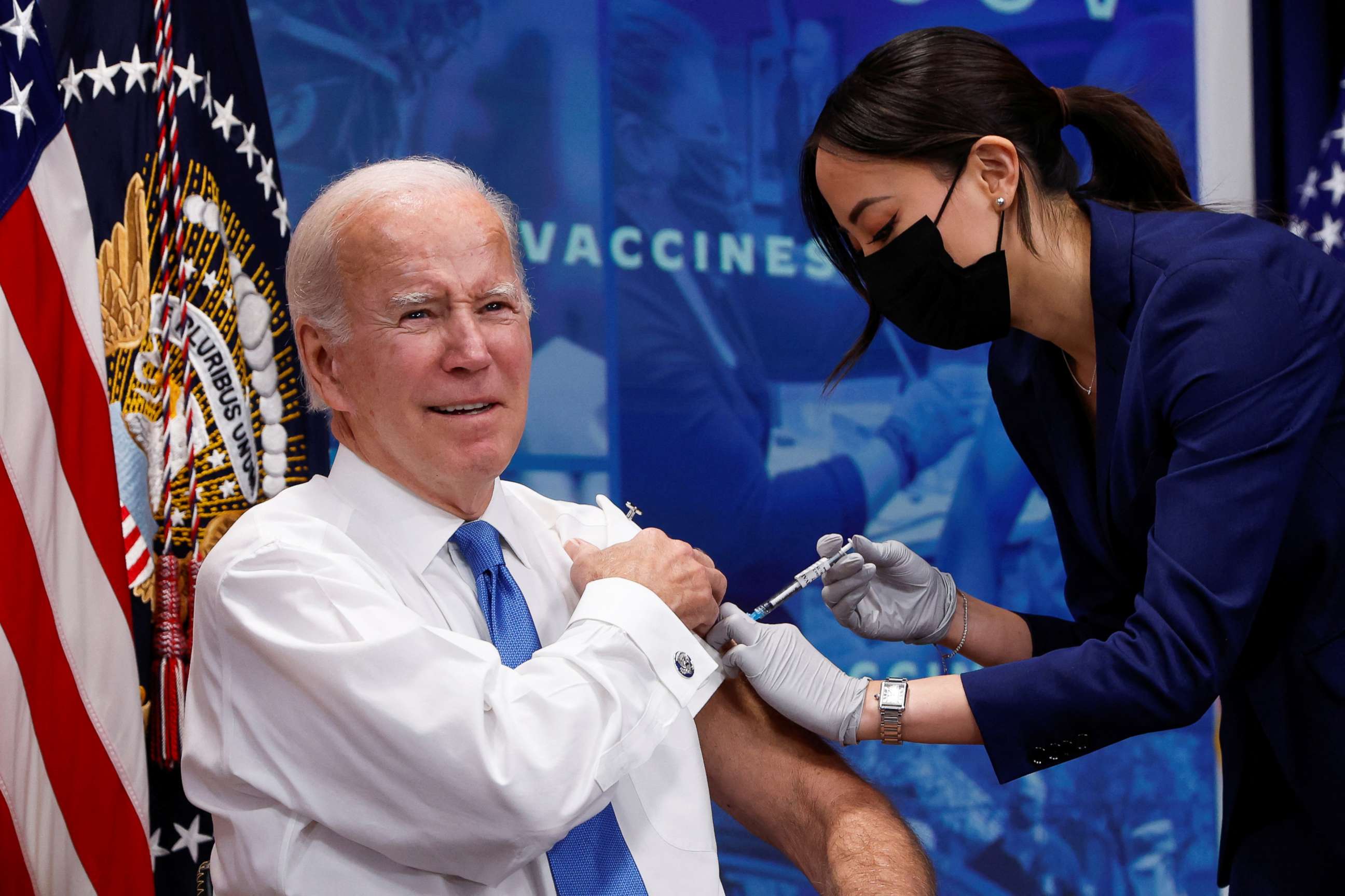 PHOTO: President Joe Biden receives an updated coronavirus disease (COVID-19) vaccine while launching a new plan for Americans to receive booster shots and vaccinations, onstage in an auditorium on the White House campus in Washington, October 25, 2022.