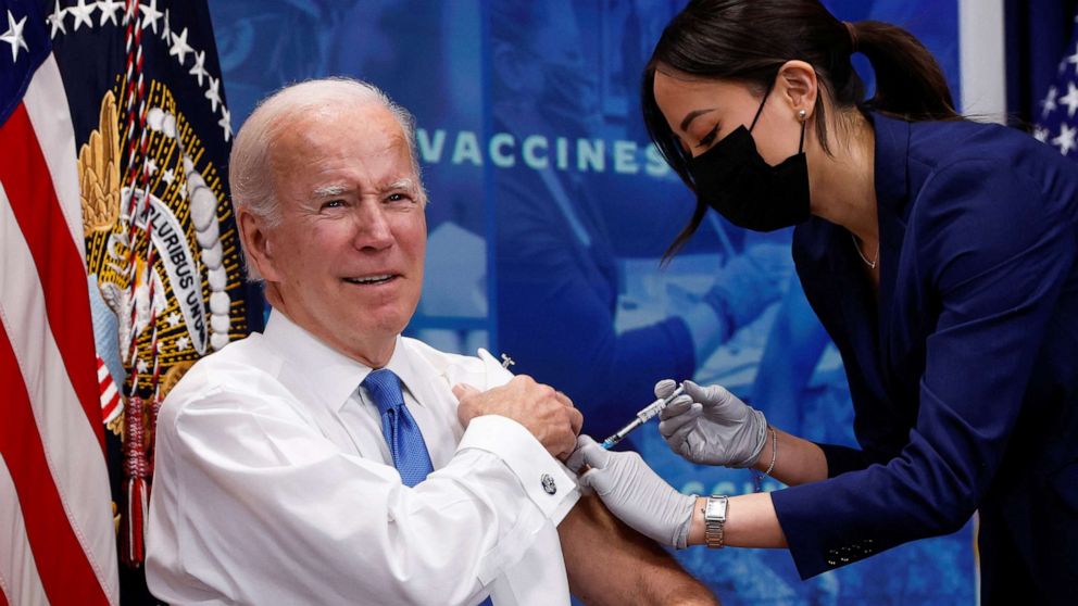 PHOTO: President Joe Biden receives an updated vaccine for the coronavirus disease (COVID-19) while launching a new plan for Americans on stage in an auditorium on the White House campus in Washington October 25, 2022 to get booster shots and vaccinations.