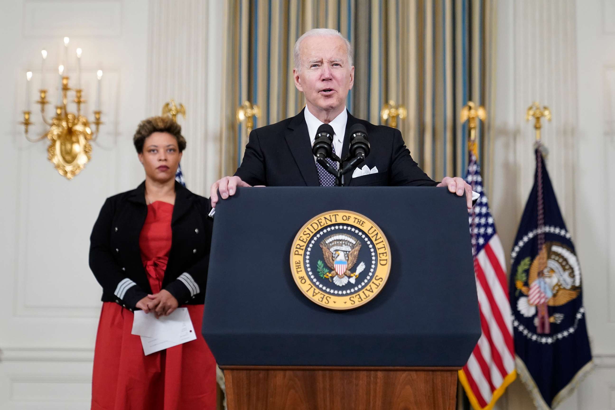 PHOTO: President Joe Biden speaks about his proposed budget for fiscal year 2023 in the State Dining Room of the White House, Monday, March 28, 2022, in Washington, D.C., as Office of Management and Budget acting director Shalanda Young listens.