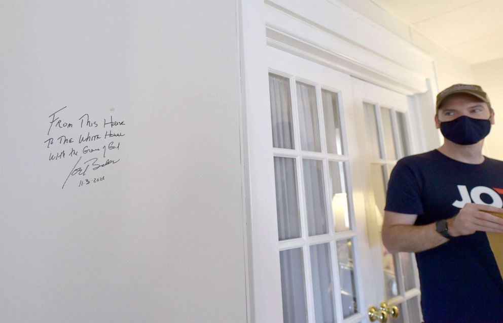 PHOTO: Chris Kearns looks at a spot where Joe Biden wrote on the wall of his childhood home, saying "From This House To The White House With the Grace of God."