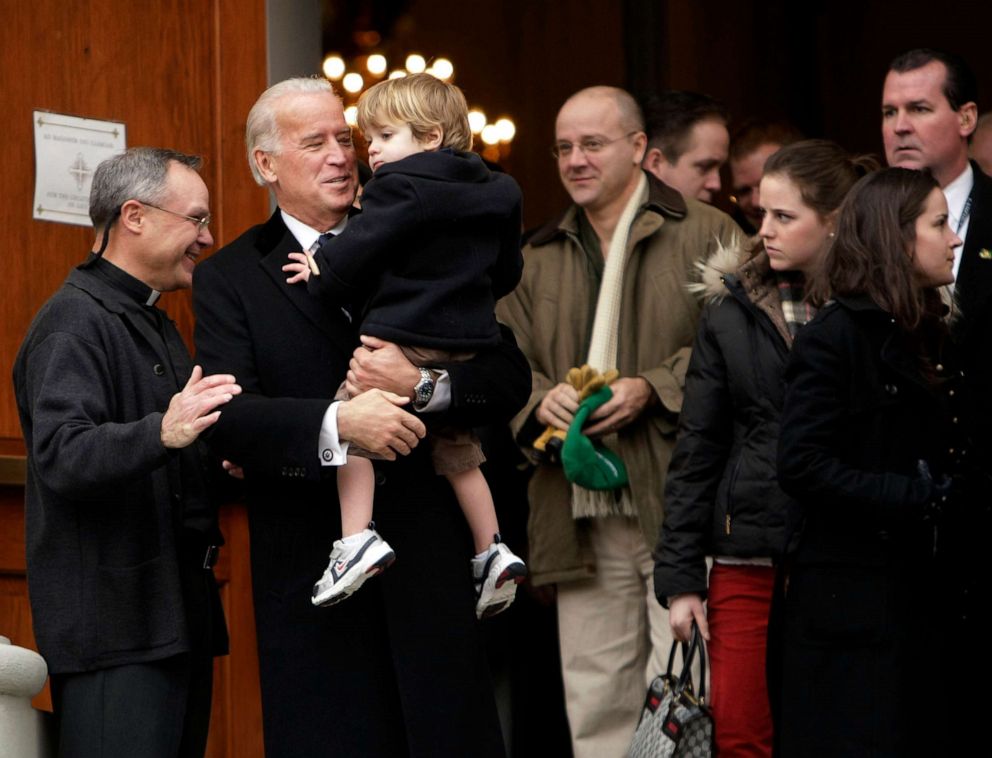 PHOTO: Vice President-elect Joe Biden greets Father Mark Horak as he holds his grandson, Robert Hunter Biden, 2, after attending Mass at Holy Trinity Catholic Church in the Georgetown section of Washington, Jan. 18, 2009.