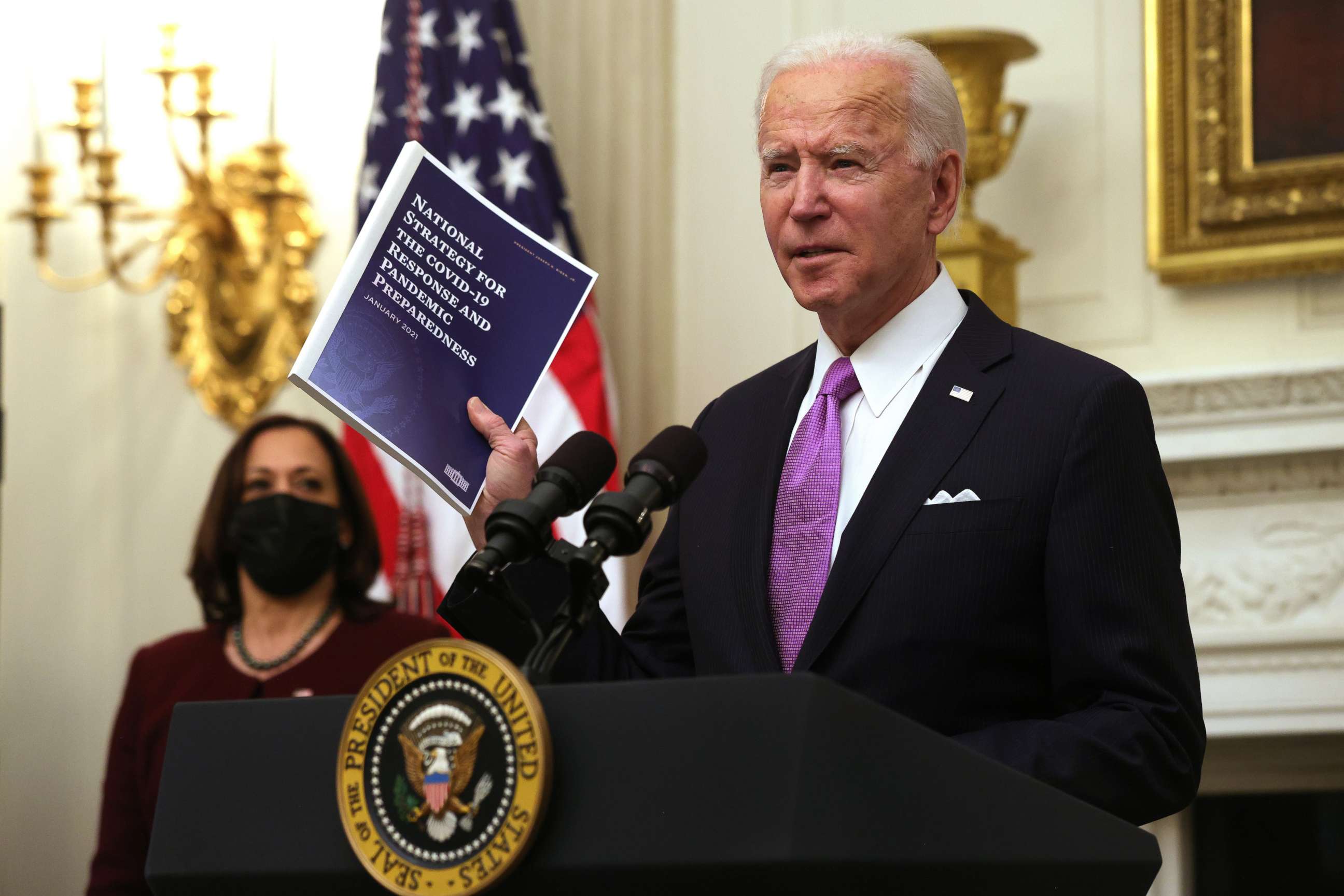 PHOTO: President Joe Biden speaks as Vice President Kamala Harris looks on during an event in the State Dining Room of the White House, Jan. 21, 2021, in Washington, DC.