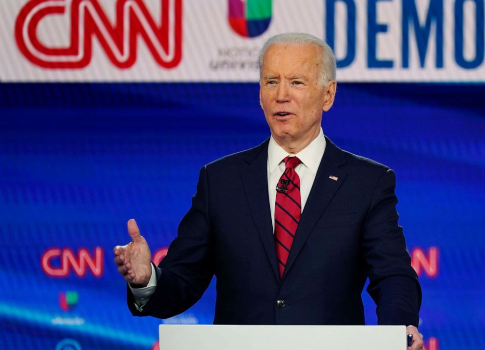 In this Sunday, March 15, 2020, photo, former Vice President Joe Biden, with Sen. Bernie Sanders, I-Vt., speaks during a Democratic presidential primary debate at CNN Studios in Washington. 