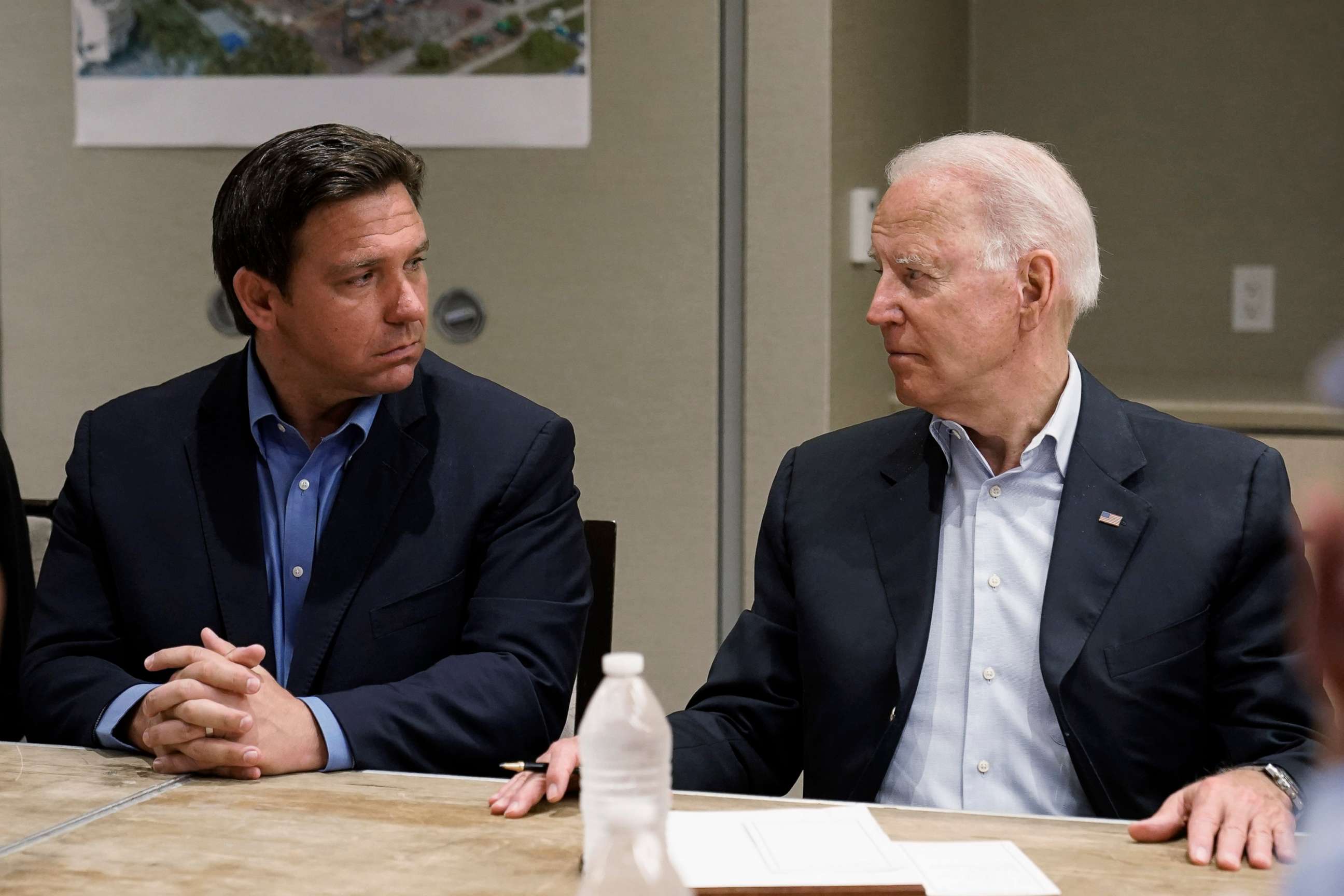 PHOTO: President Joe Biden looks at Florida Gov. Ron DeSantis during a briefing with first responders and local officials in Miami, July 1, 2021, on the condo tower that collapsed in Surfside, Fla., last week.