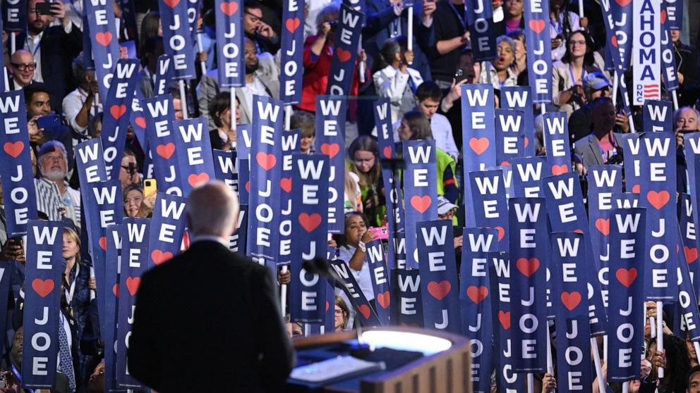 PHOTO: Delegates hold up signs as US President Joe Biden speaks on the first day of the Democratic National Convention at the United Center in Chicago,Aug. 19, 2024.