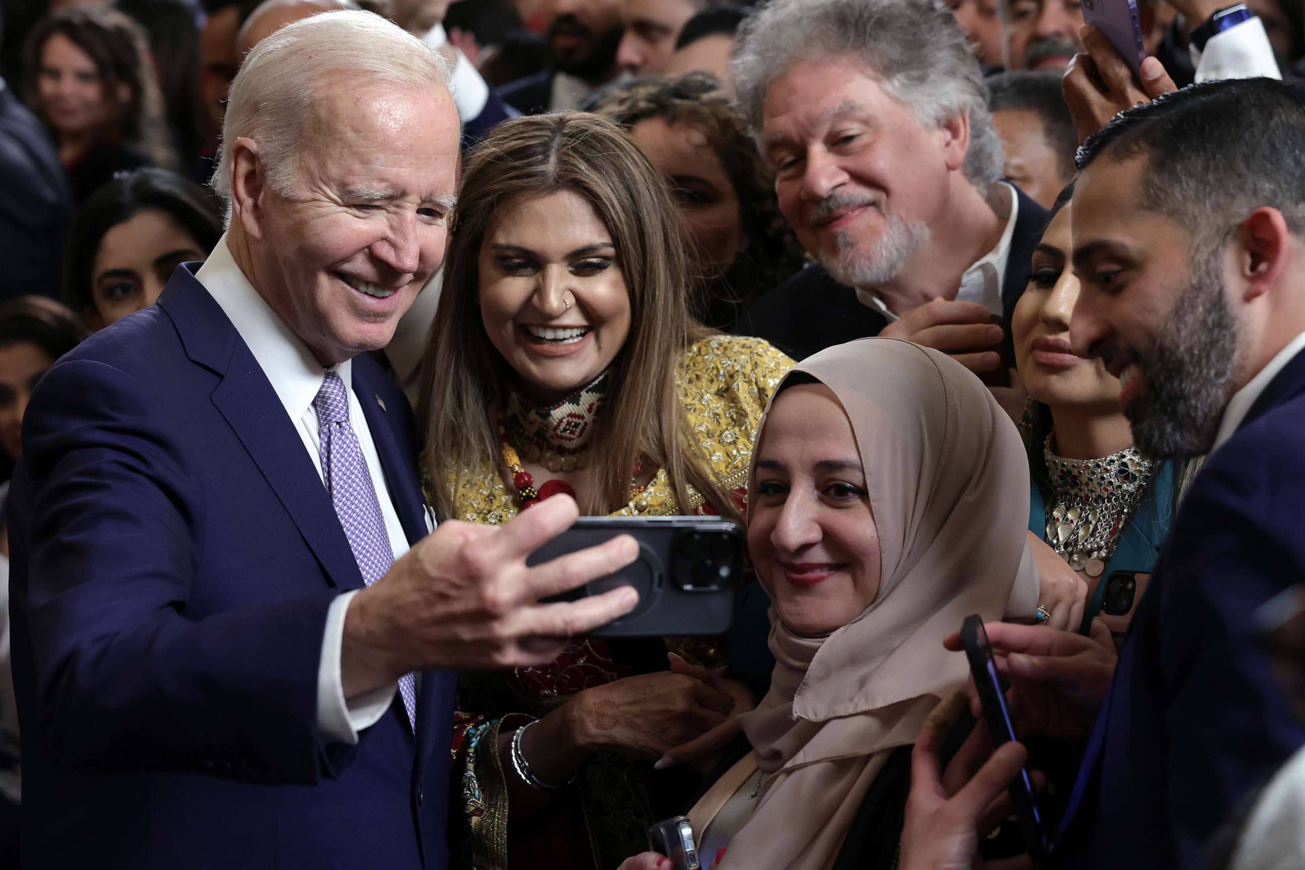 PHOTO: President Joe Bidentakes selfies with guests during a reception celebrating Eid-al-Fitr in the East Room of the White House, May 1, 2023.