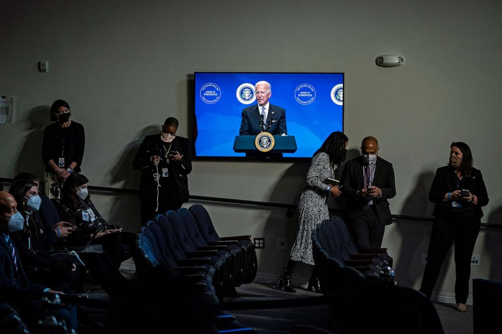 PHOTO: People listen as President Joe Biden speaks about American manufacturing before signing an executive order in the South Court Auditorium on the White House complex on Jan 25, 2021, in Washington, D.C.