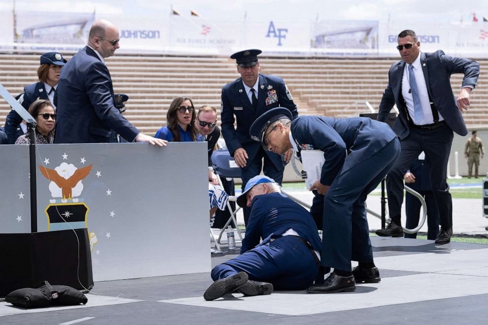 PHOTO: President Joe Biden is helped up after falling during the graduation ceremony at the United States Air Force Academy, just north of Colorado Springs, Colorado, June 1, 2023.