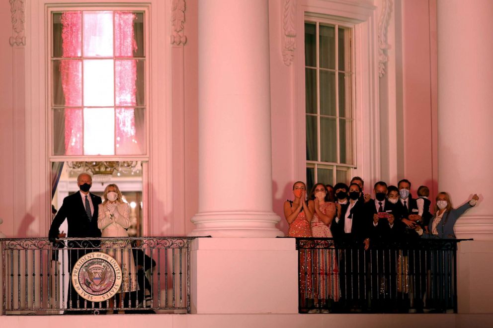 PHOTO: President Joe Biden and First Lady Dr. Jill Biden watch a fireworks display beside family and staff members from the Truman Balcony of the White House in Washington, Jan. 20, 2021.