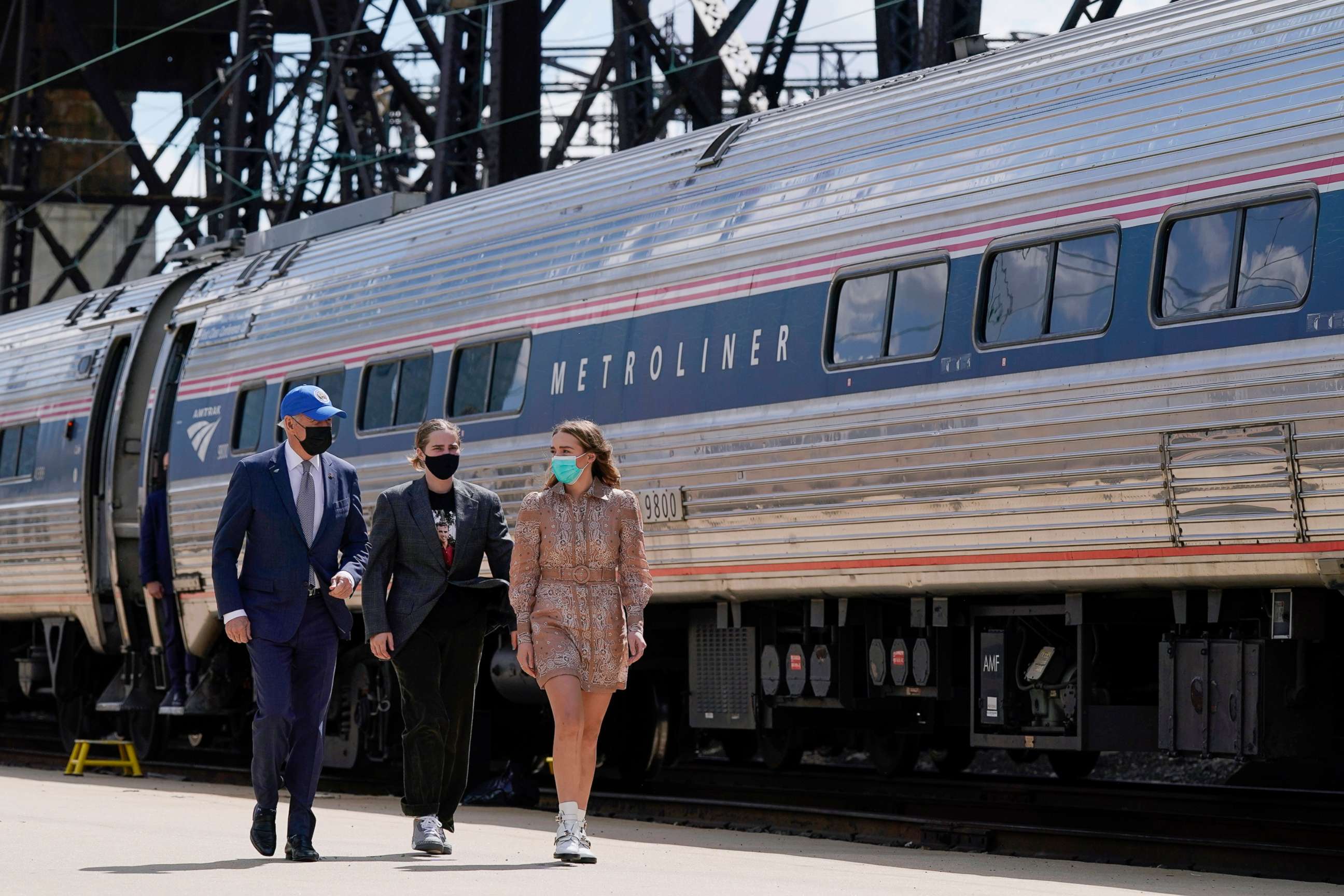 PHOTO: President Joe Biden walks with his granddaughters Maisy Biden, center, and Finnegan Biden as he arrives to speak at an event to mark Amtrak's 50th anniversary at 30th Street Station in Philadelphia, April 30, 2021.