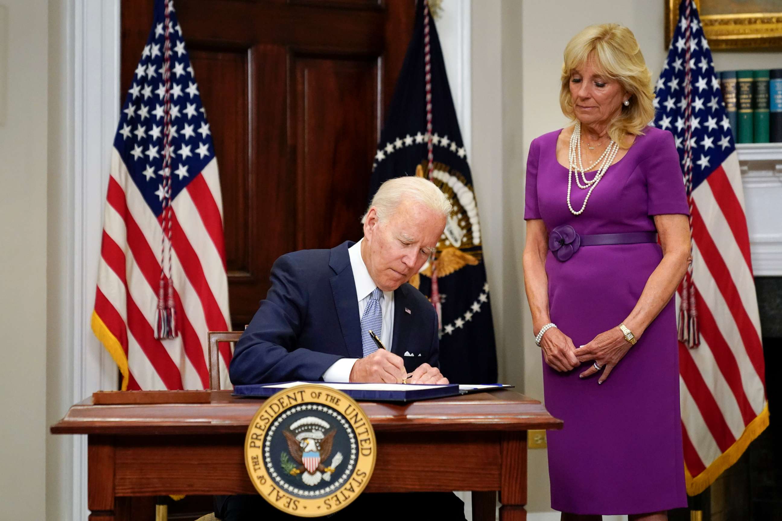 PHOTO: President Joe Biden signs into law S. 2938, the Bipartisan Safer Communities Act gun safety bill, in the Roosevelt Room of the White House in Washington, June 25, 2022.