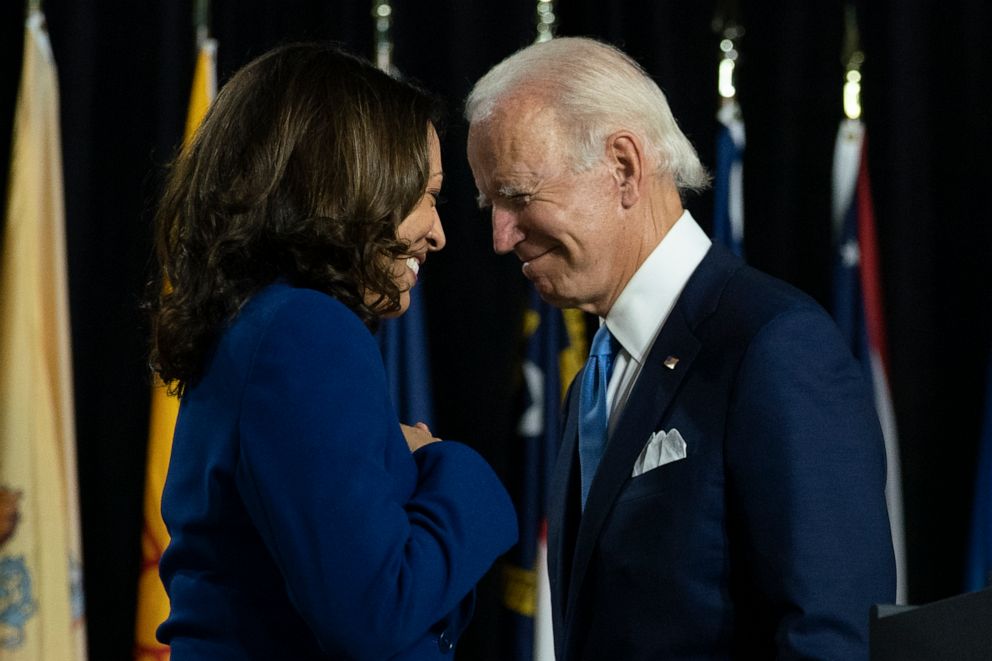 PHOTO: Democratic presidential candidate former Vice President Joe Biden and his running mate Sen. Kamala Harris pass each other during a campaign event at Alexis Dupont High School in Wilmington, Del.