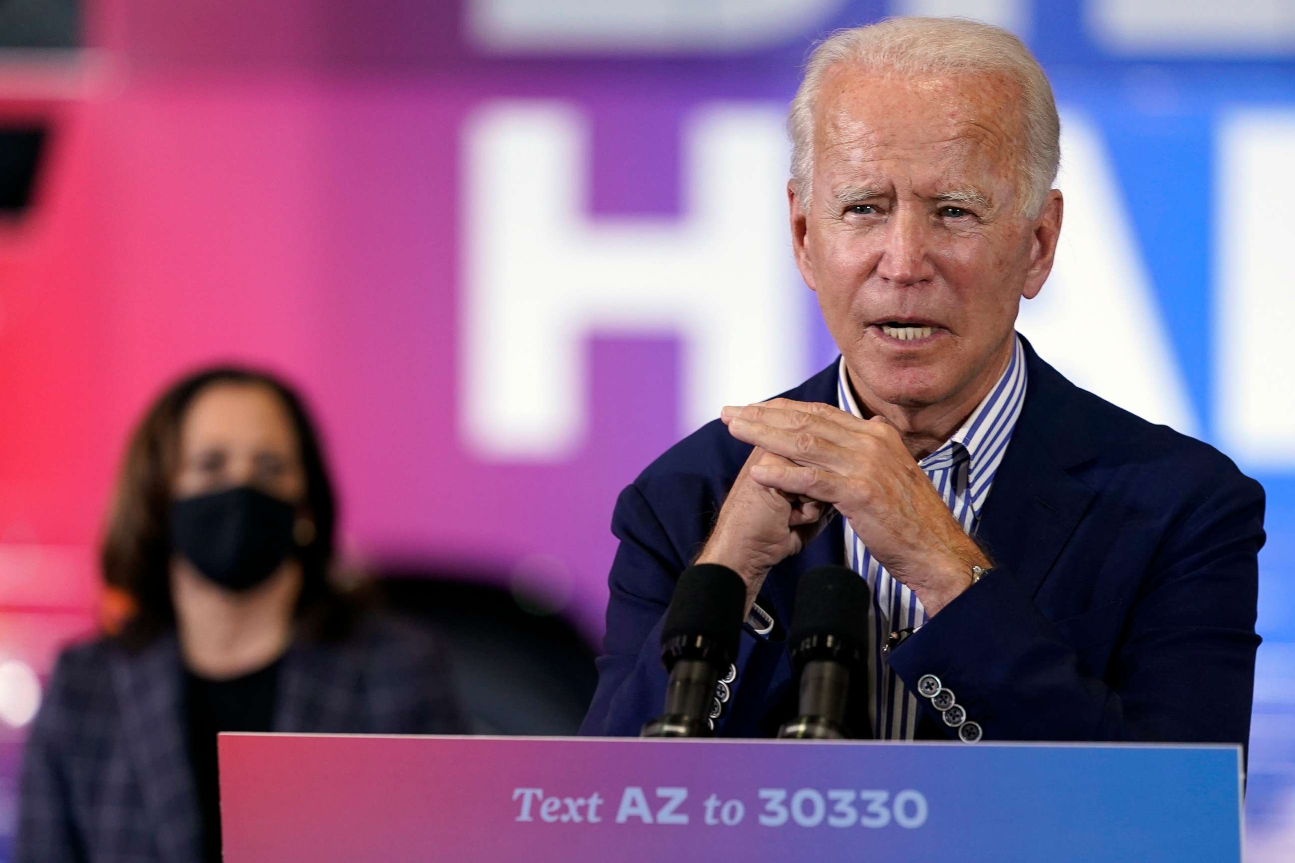 PHOTO: Democratic presidential candidate former Vice President Joe Biden speaks as Democratic vice presidential candidate Sen. Kamala Harris, listens at the Carpenters Local Union 1912 in Phoenix, Oct. 8, 2020.