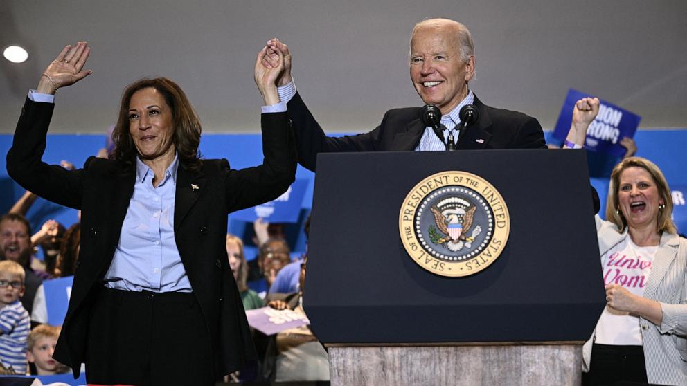 PHOTO: President Joe Biden holds up Vice President and Democratic presidential candidate Kamala Harris's hand during a campaign rally at the International Brotherhood of Electrical Workers (IBEW) Local 5 in Pittsburgh, Pennsylvania, on Sept. 2, 2024.