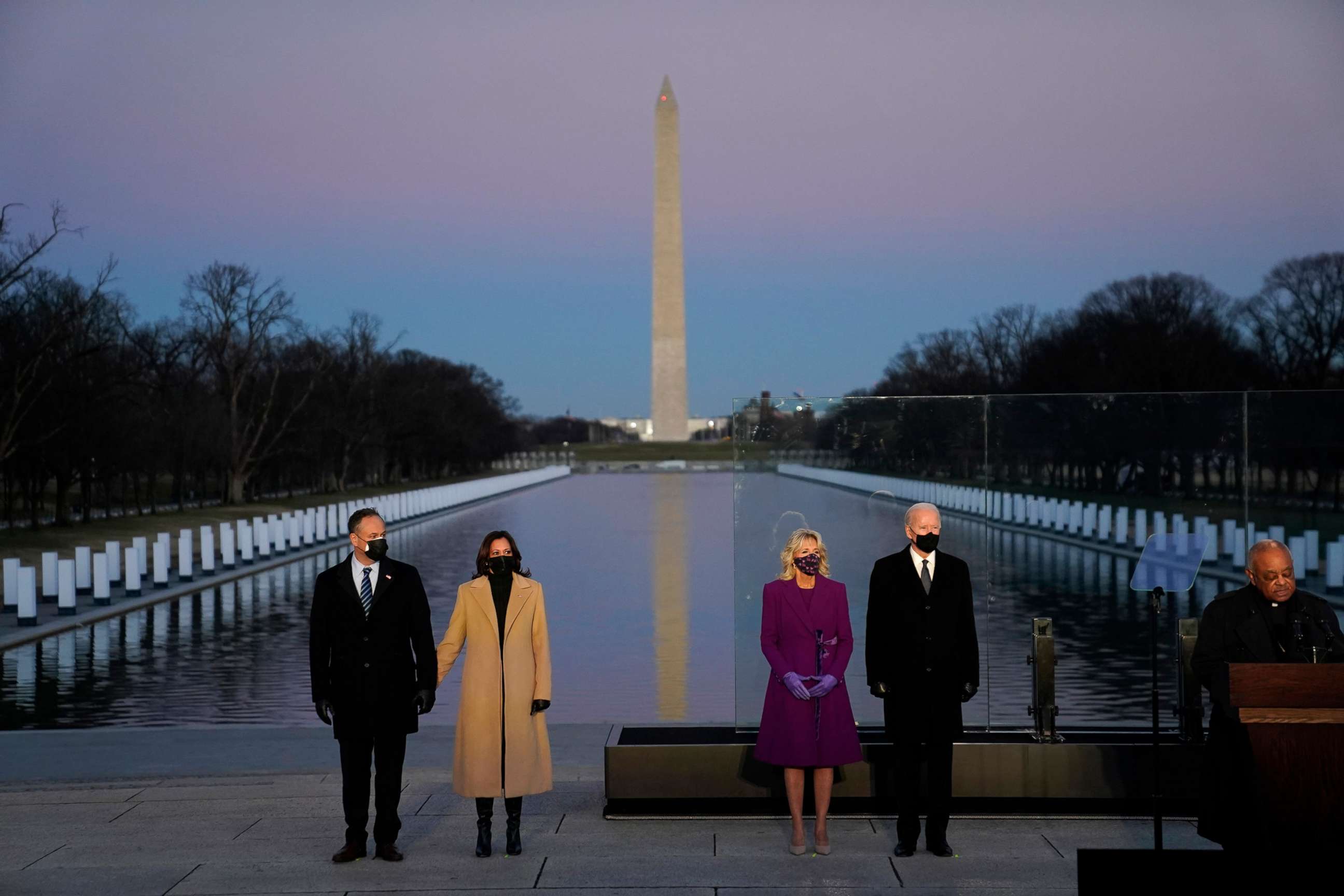 PHOTO: President-elect Joe Biden with his wife Jill Biden and Vice President-elect Kamala Harris with her husband Doug Emhoff listen to Cardinal Wilton Daniel Gregory speak during a COVID-19 memorial, Jan. 19, 2021, in Washington, D.C.